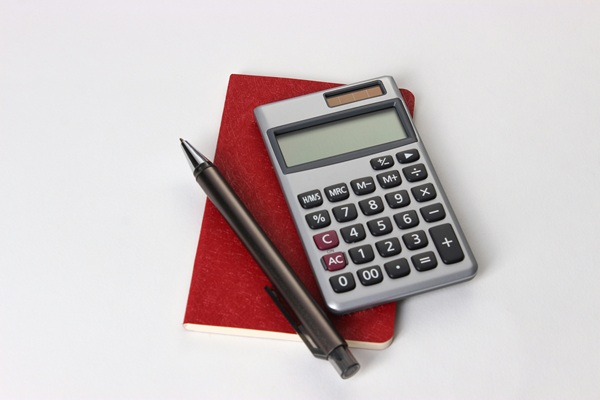calculator and pen to help with the calculations of the non-resident tax certificate, requested on the Tax Office Portal