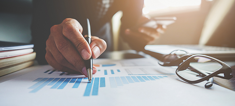Person hand pointing to chart