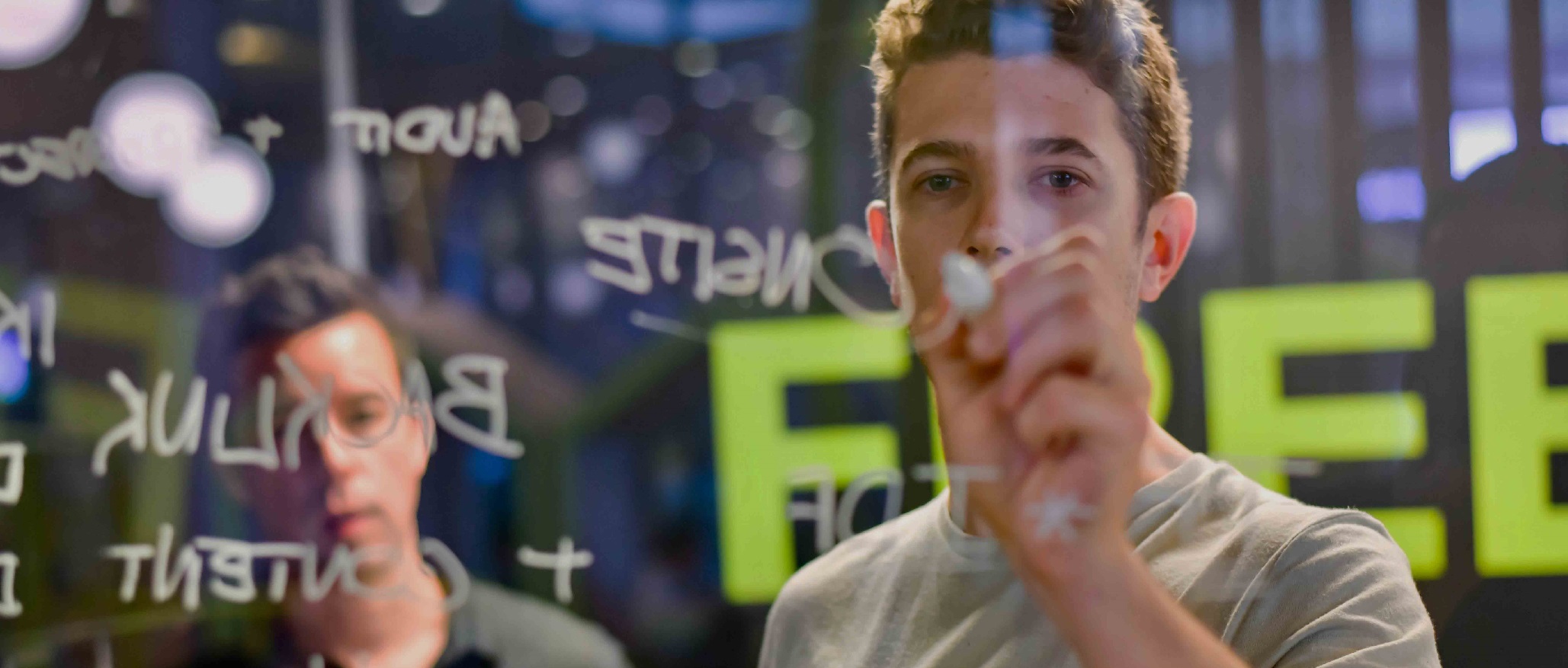 Man sketching ideas on a board